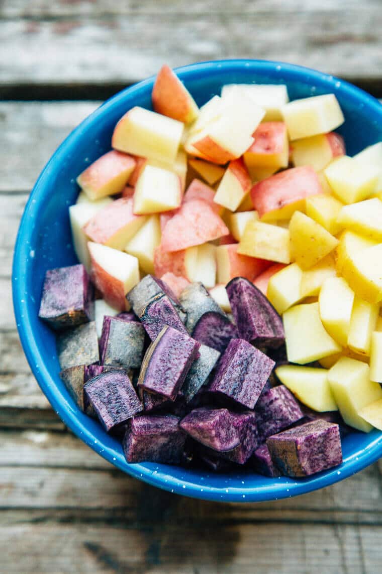 Colorful chopped potatoes in a blue bowl