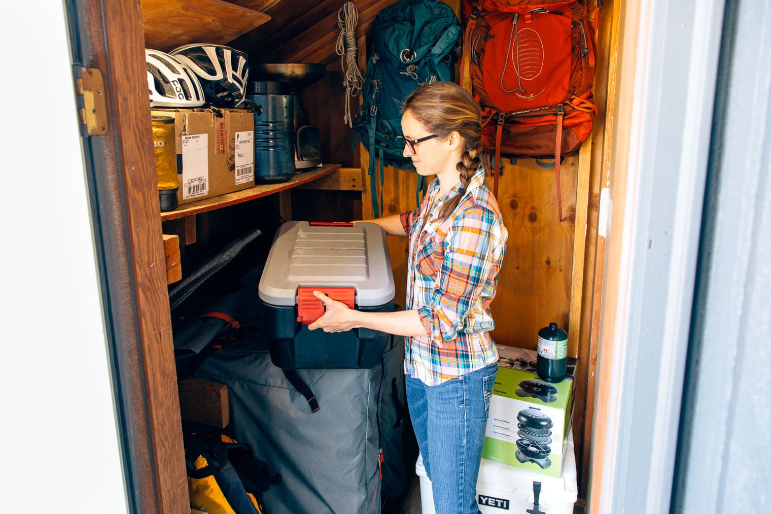 Megan lifting an action packer off of a shelf