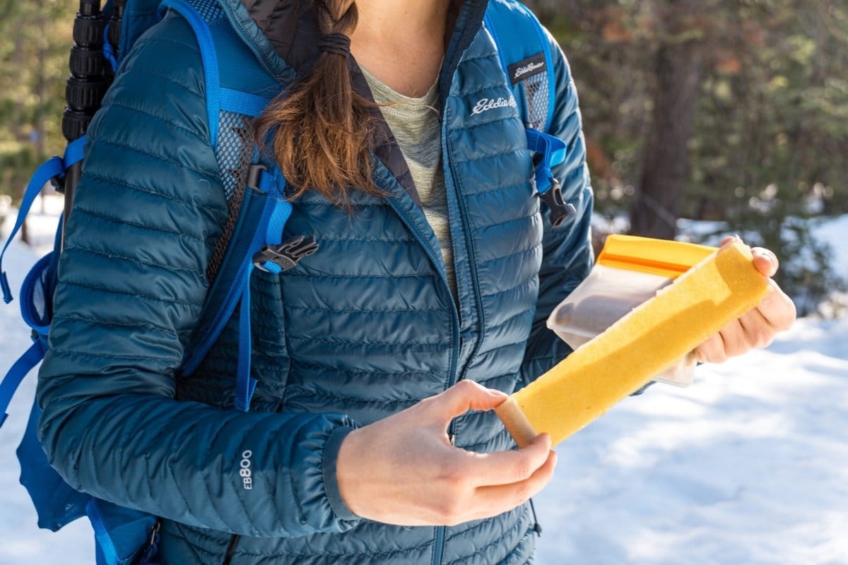 Megan holding a fruit leather on a hike