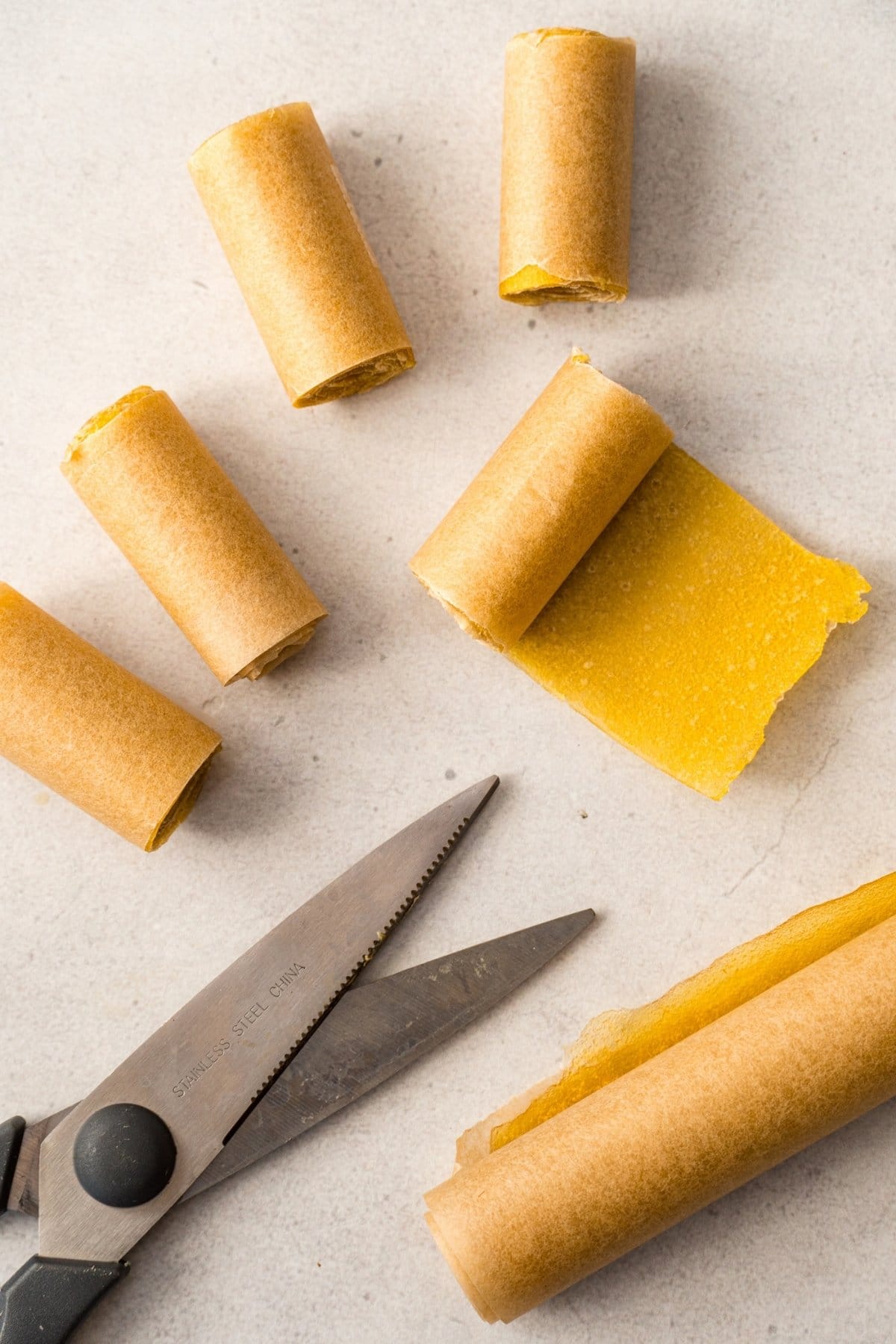 Cutting fruit rolls into 1" sections for storage