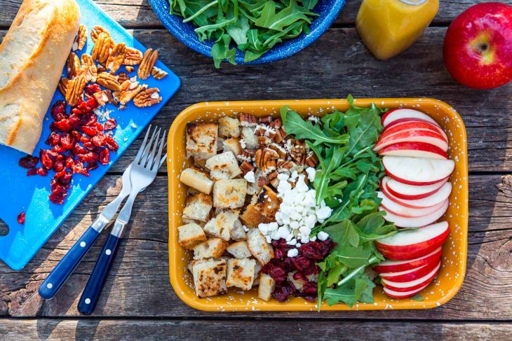 Ingredients for panzanella salad displayed in a yellow dish