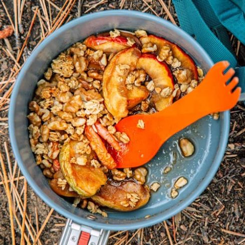 Apple crisp in a backpacking pot on a bed of pine needles