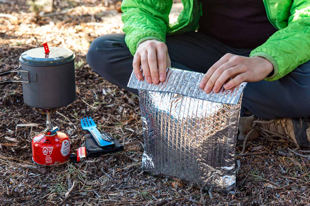 Megan folding the top edge over a insulating pouch cozy