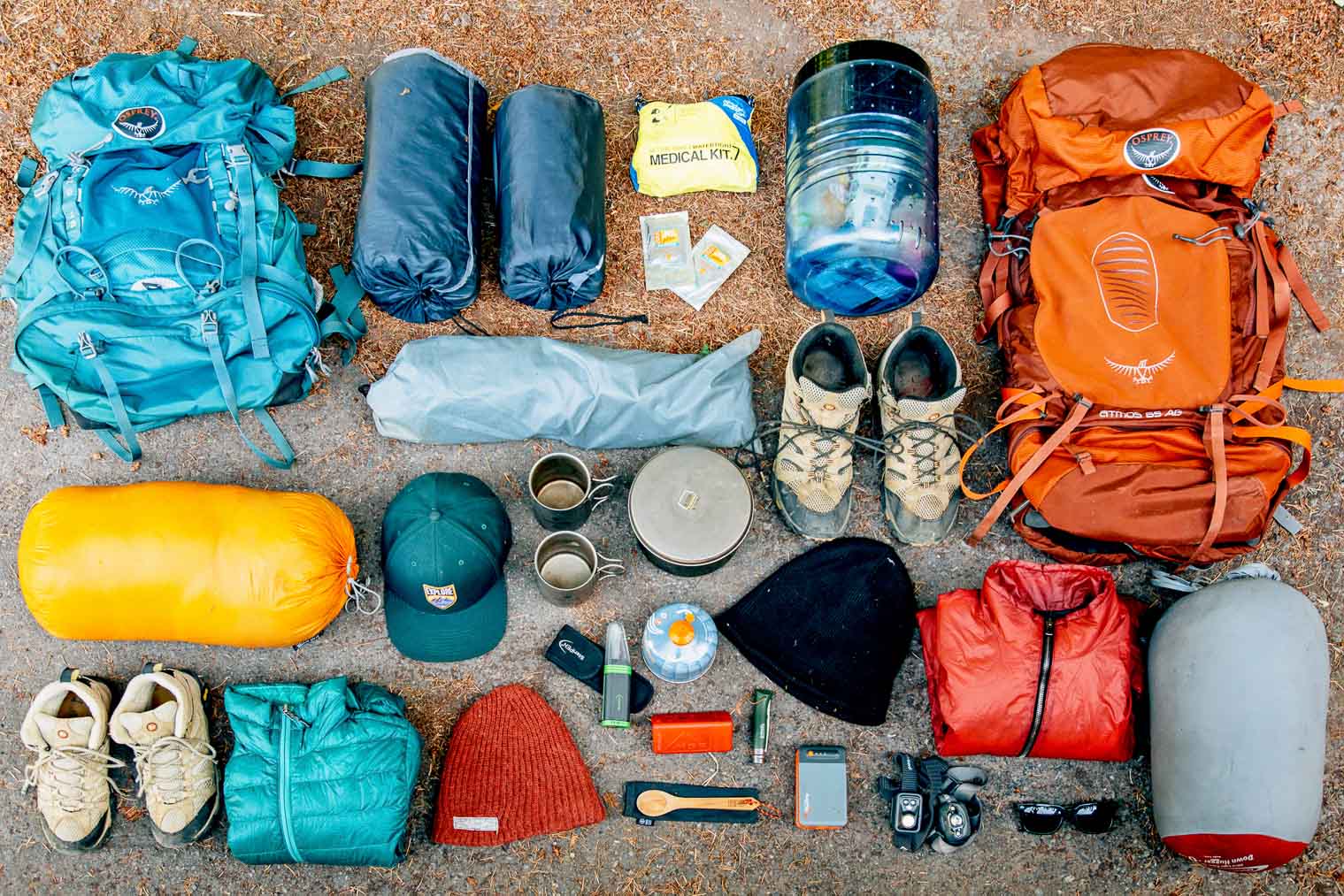 Backpacking gear laid out on the ground