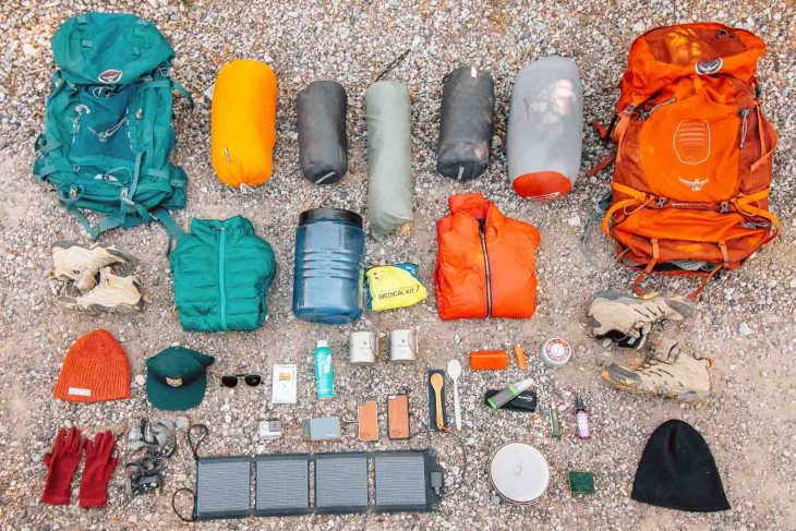 Backpacking gear laid out on the ground