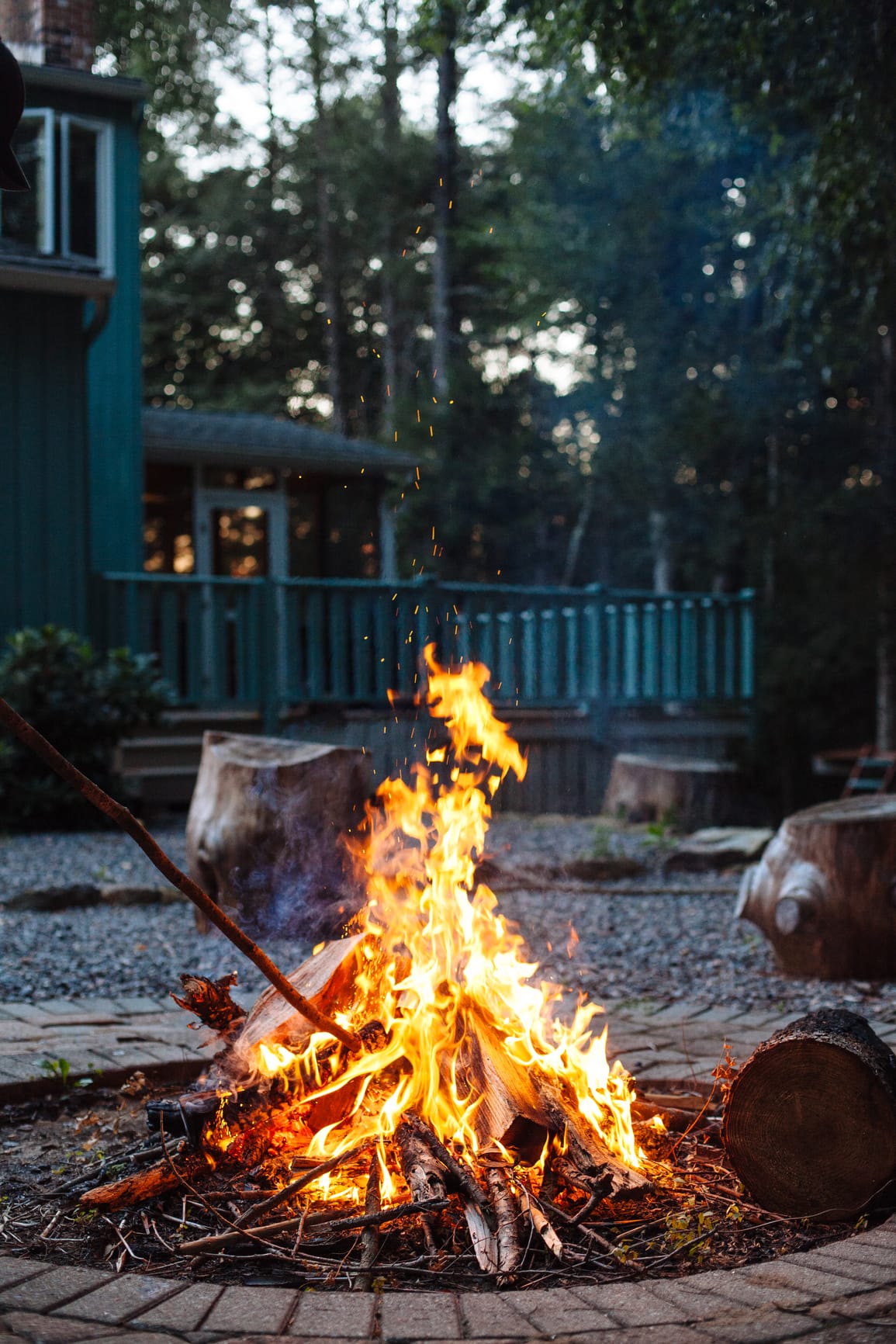 A bonfire with a house in the background