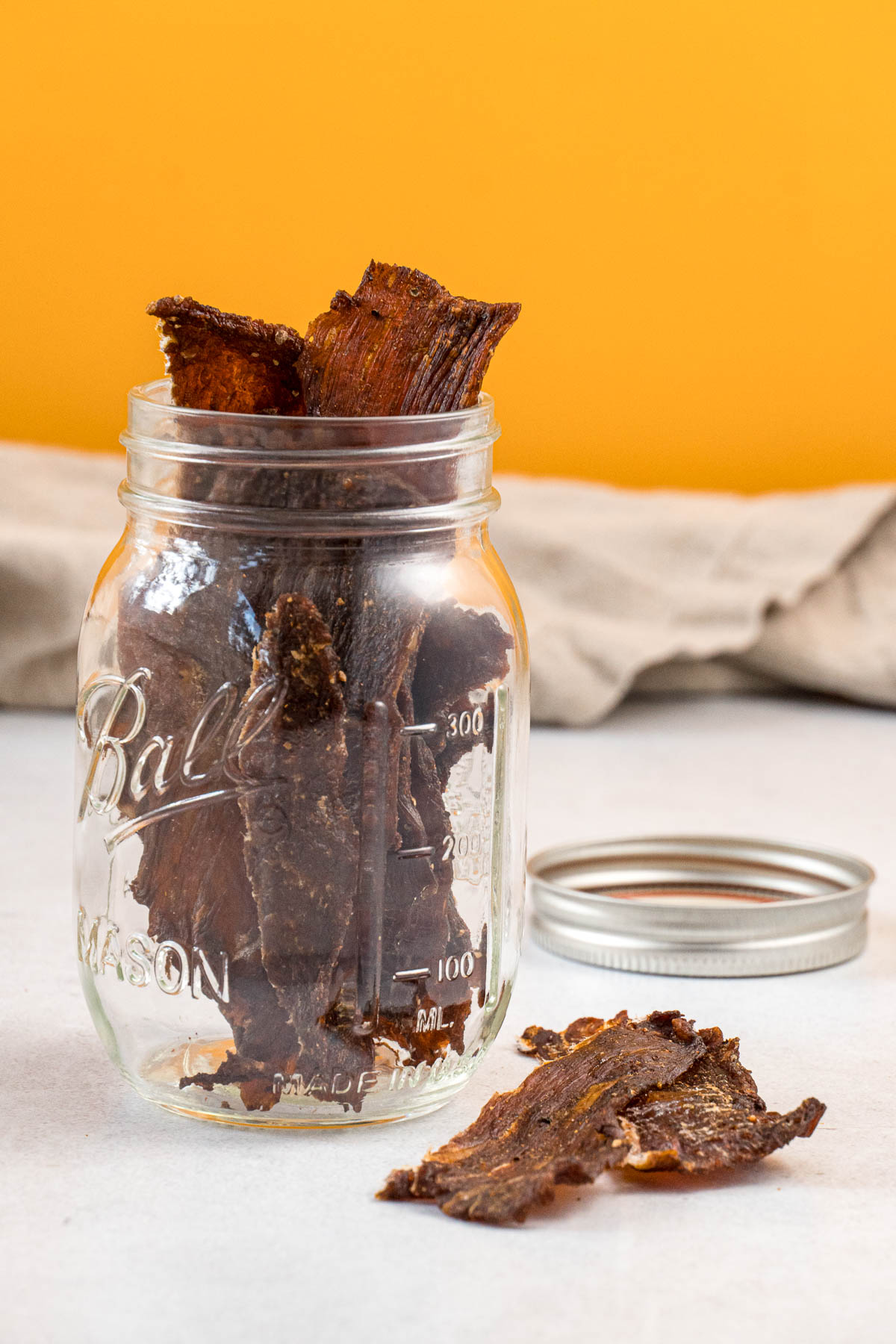 Homemade beef jerky in a mason jar for storage