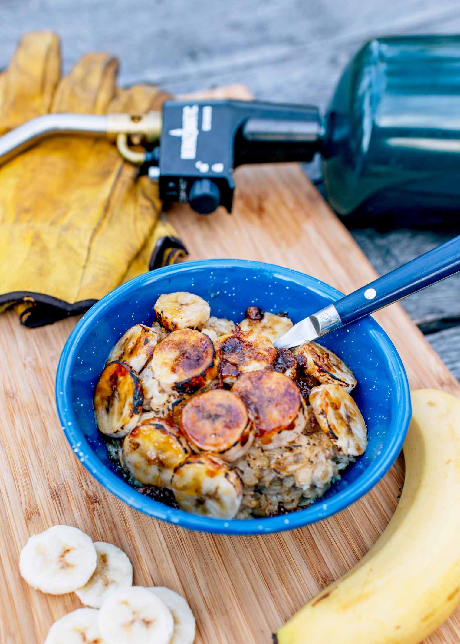 A bowl of oatmeal topped with bruleed bananas