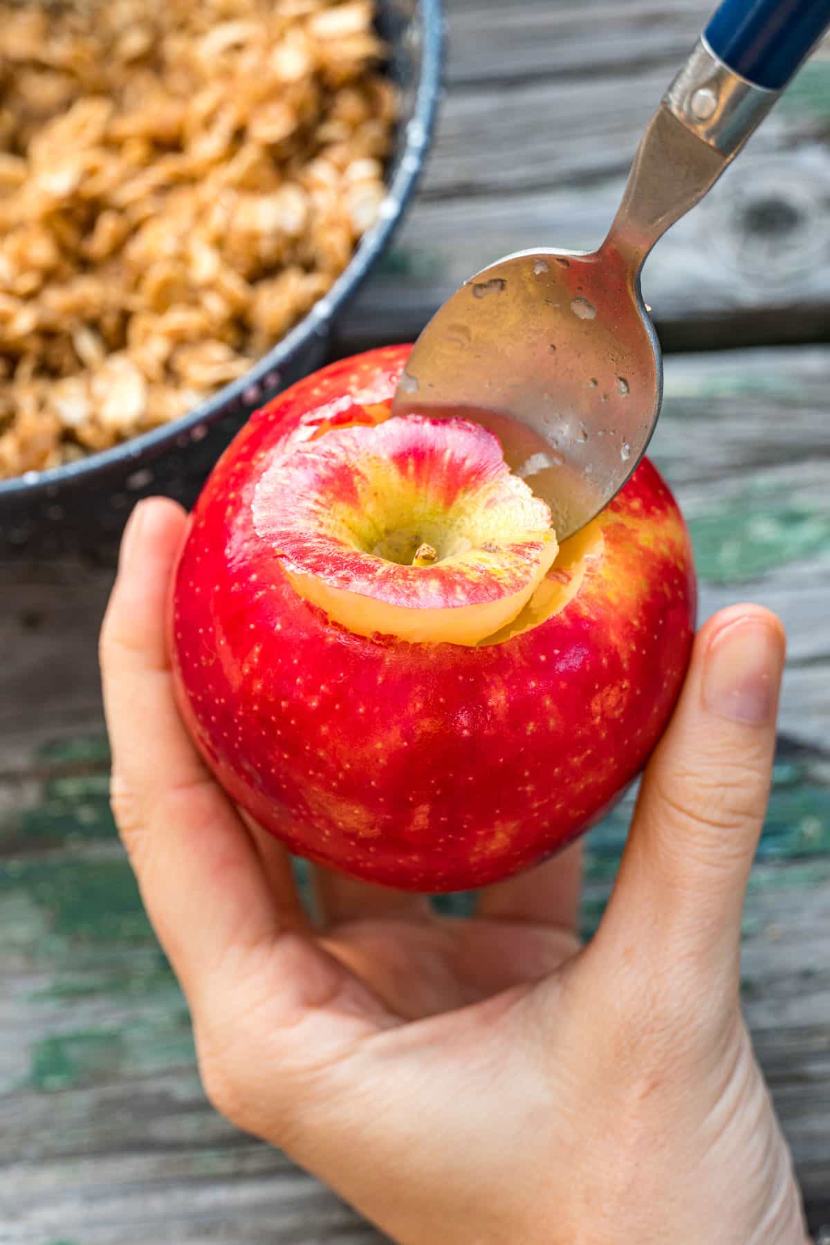 Carving the top off of an apple.