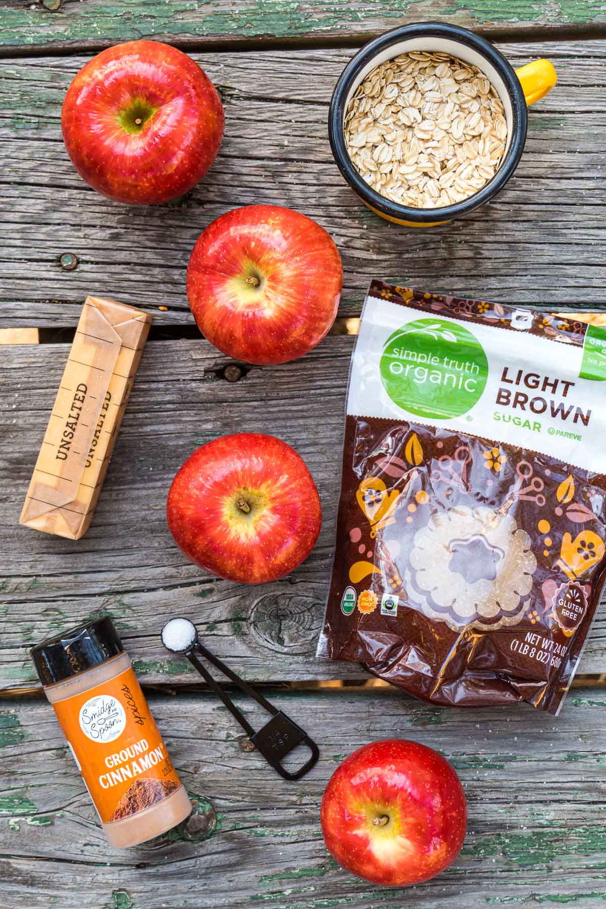 Ingredients to make camping apples laid out on a wood table.