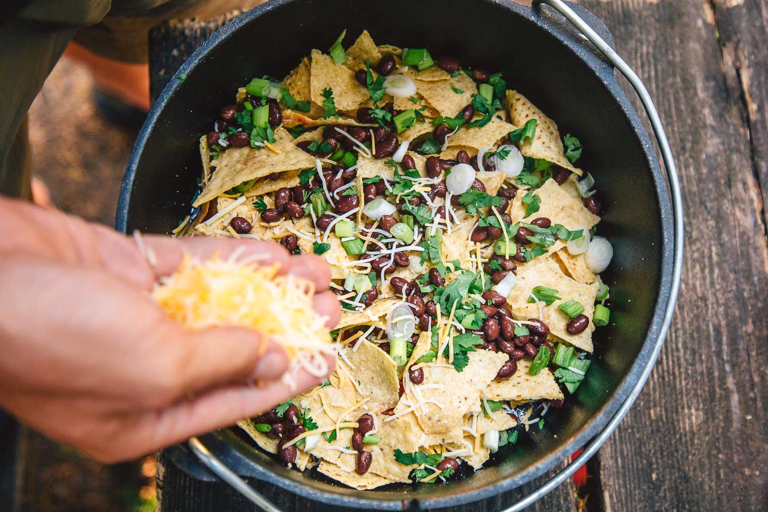 Campfire Nachos made in a Dutch oven are a simple, fast, and easy camping meal that the whole family will enjoy.