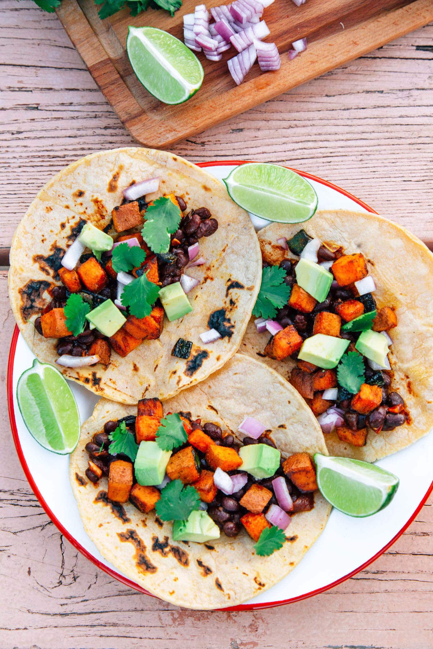 Three sweet potato and black bean tacos on a plate