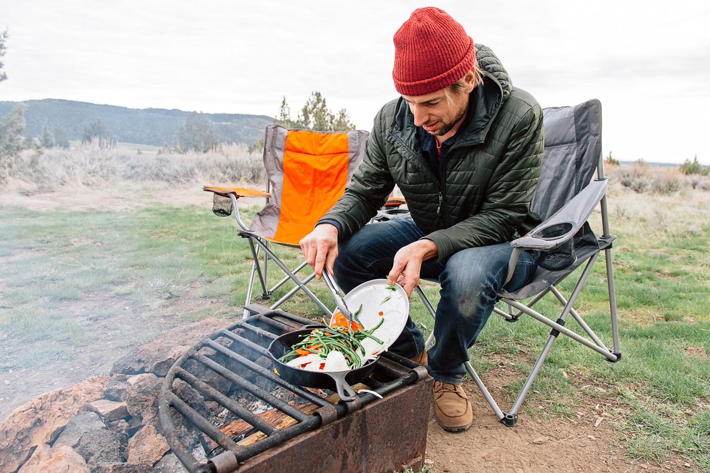 Cast Iron Brats are an easy campfire meal. Topped with sweet & spicy peppers and onions, this is a great, cheap dinner while camping.