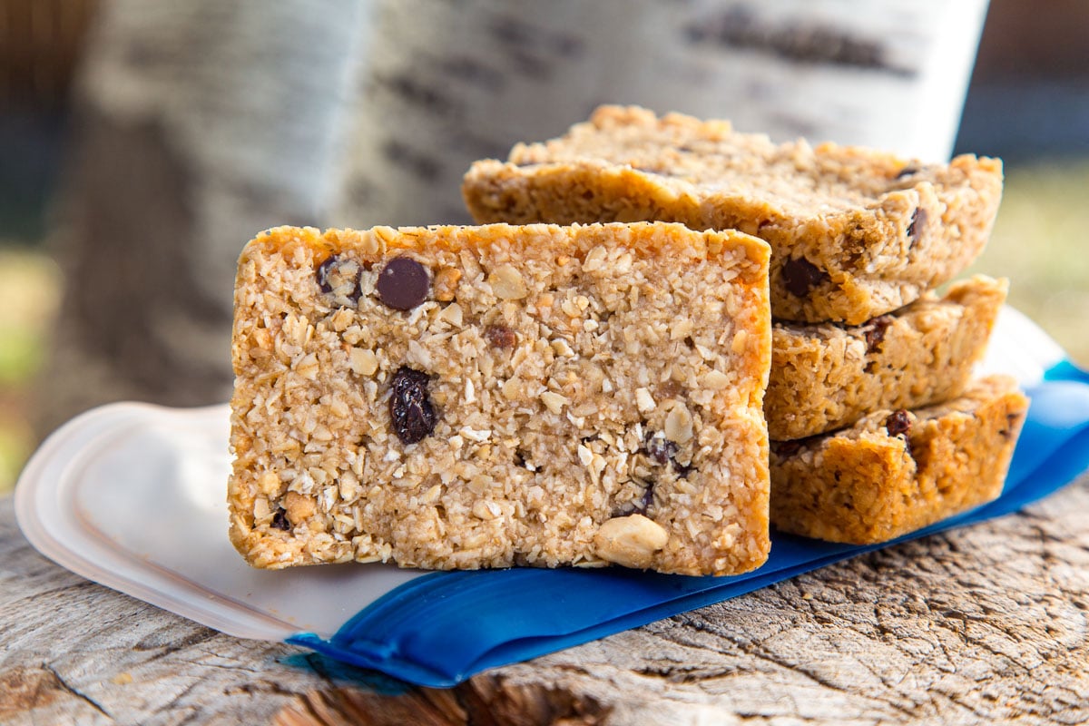 Four chewy granola bars on a stump