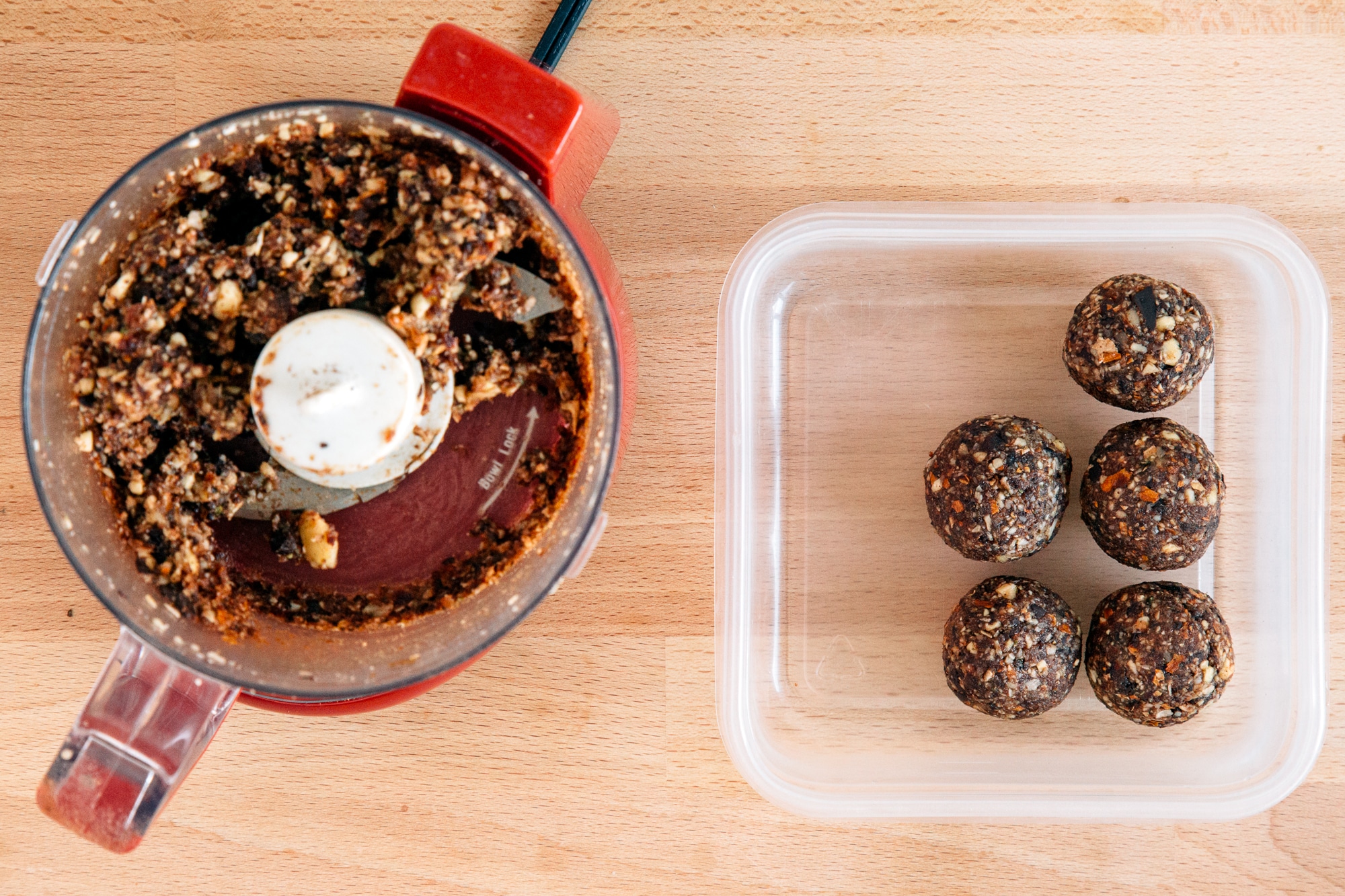 Chocolate cherry energy balls in a tupperware container