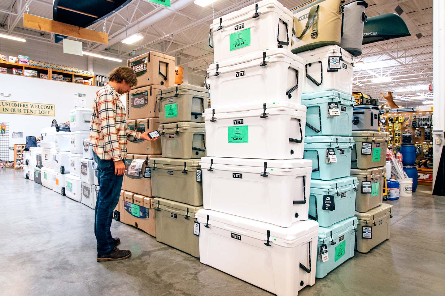 Michael in a store looking at a display of coolers