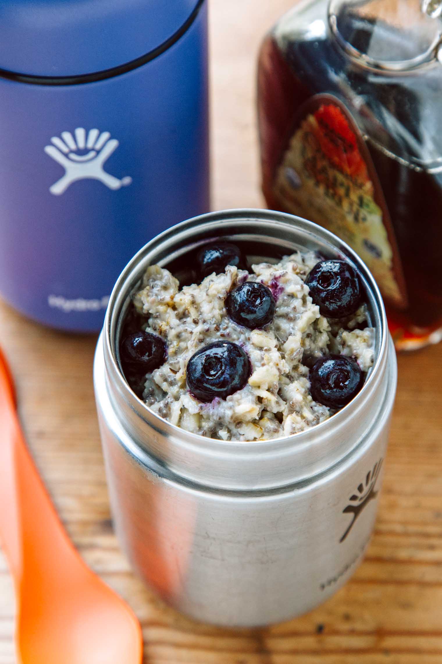 Oatmeal topped with blueberries inside a insulated food jar