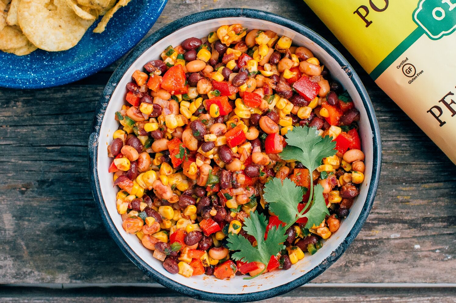 "Cowboy Caviar" in a big enamel bowl on a wooden surface.