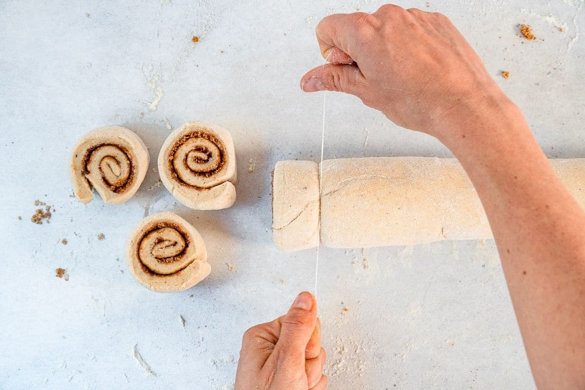 Using floss to cut cinnamon rolls