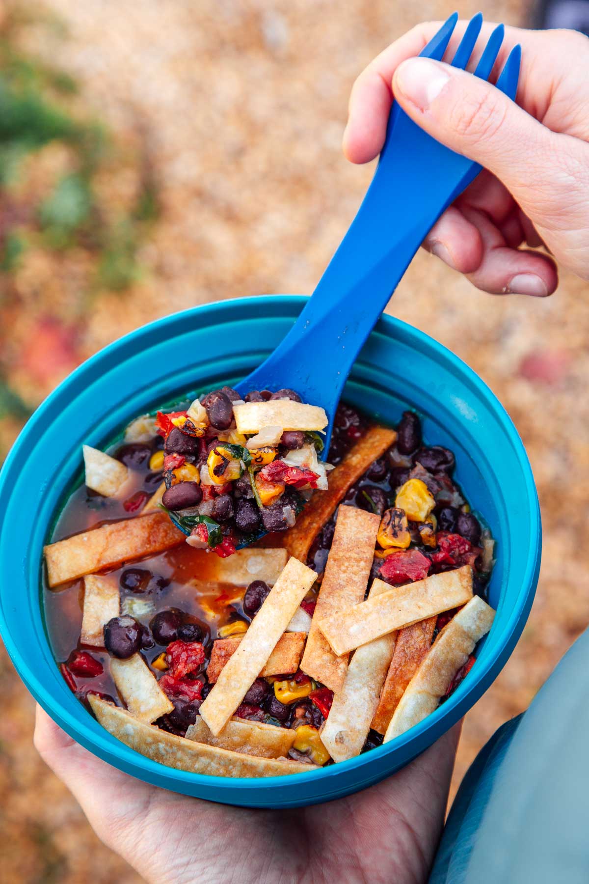 Megan holding a backpacking bowl of tortilla soup