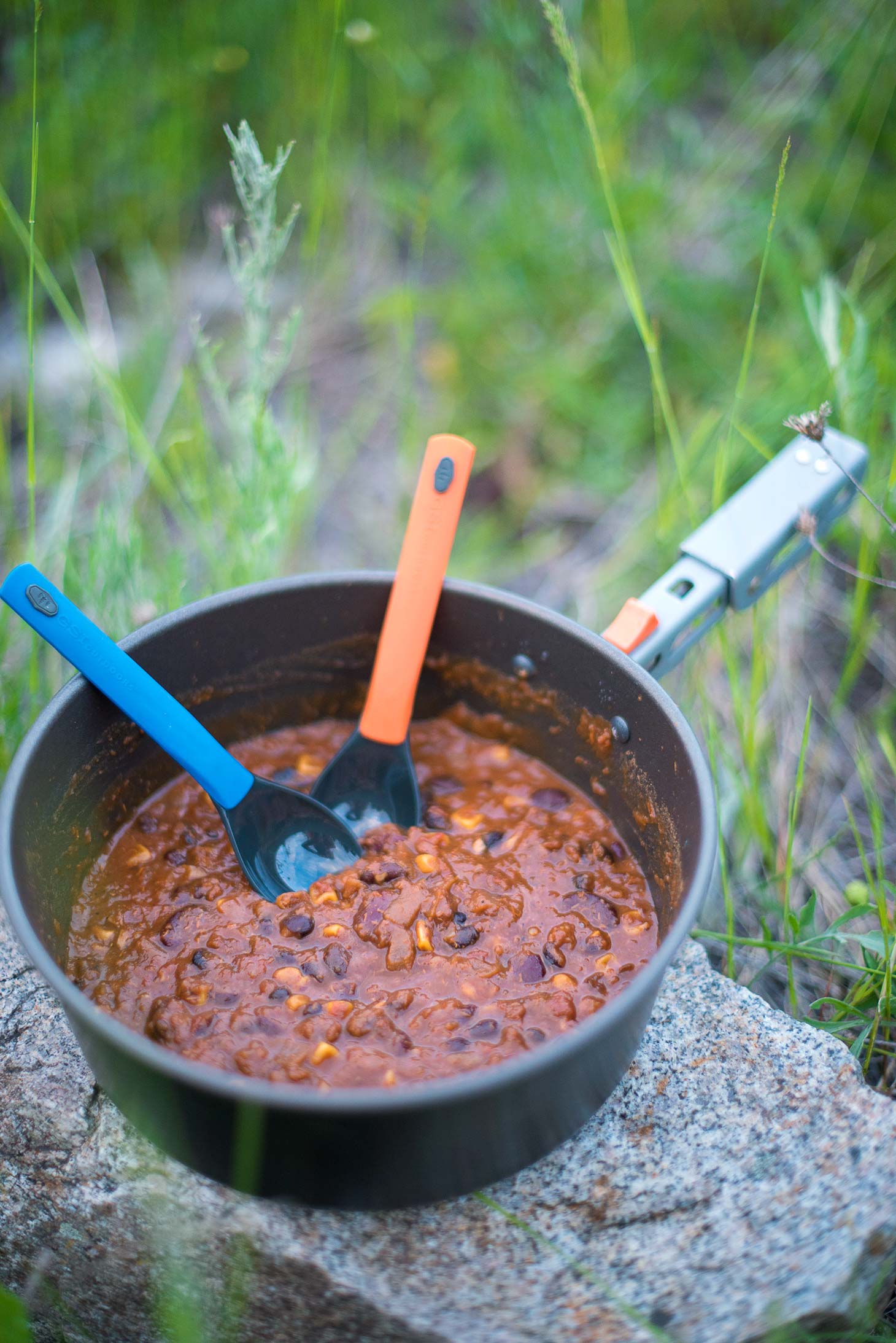 Dehydrated chili in a backpacking pot resting on a rock