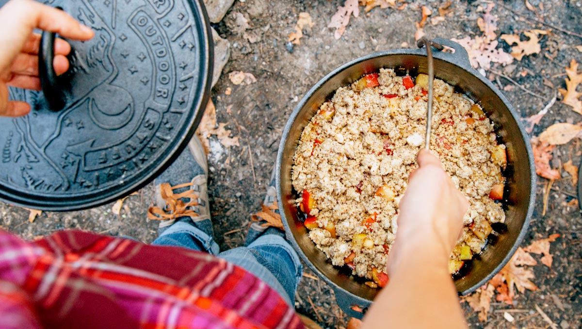 Megan carrying a apple cobbler in a Dutch oven