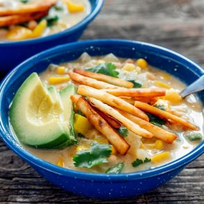 A bowl of white chili on a camp table