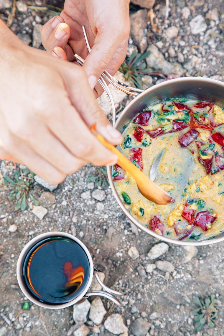 Michael scrambling eggs in a backpacking pot