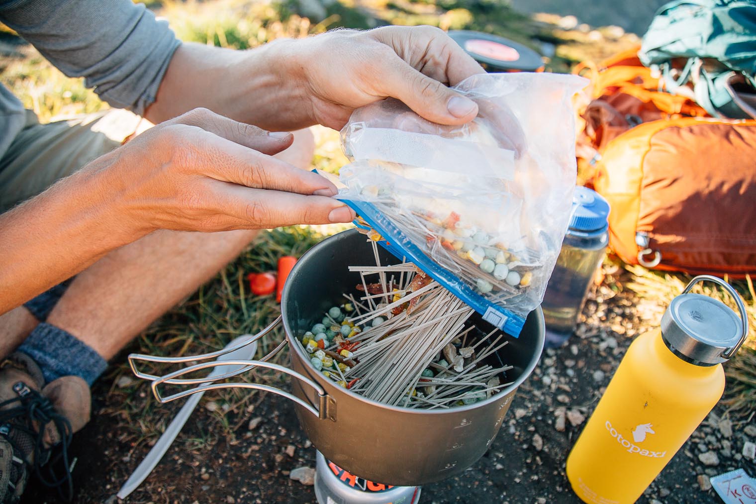 Michael adding noodles to a pot