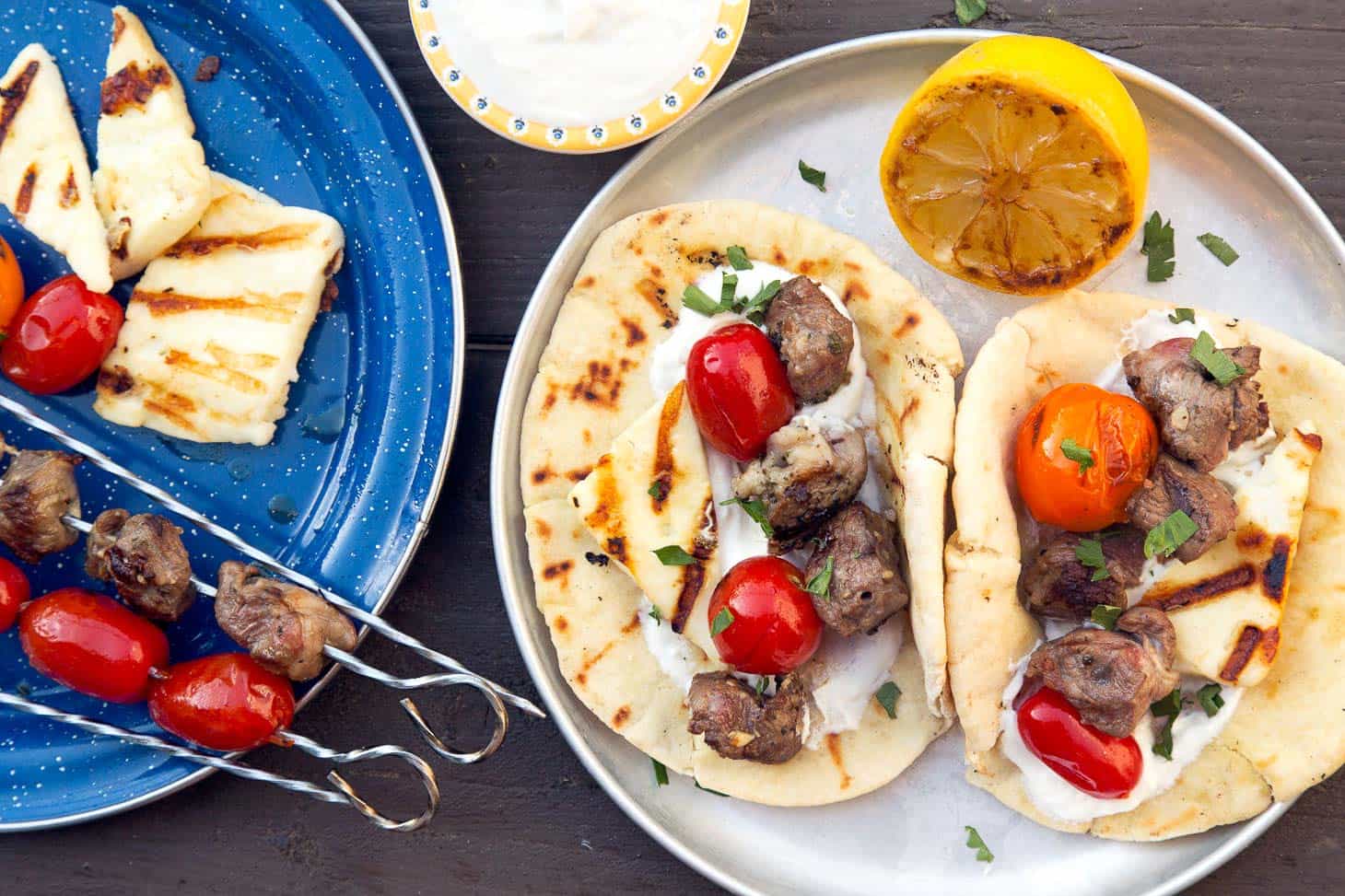 Grilled Gyros Kebabs on a silver camping plate.