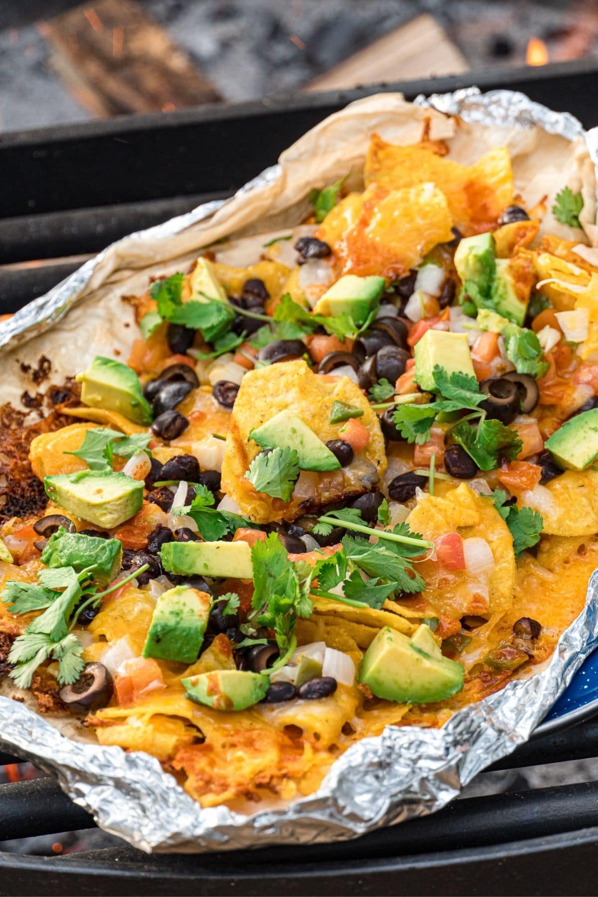 Grilled nachos in foil over a campfire