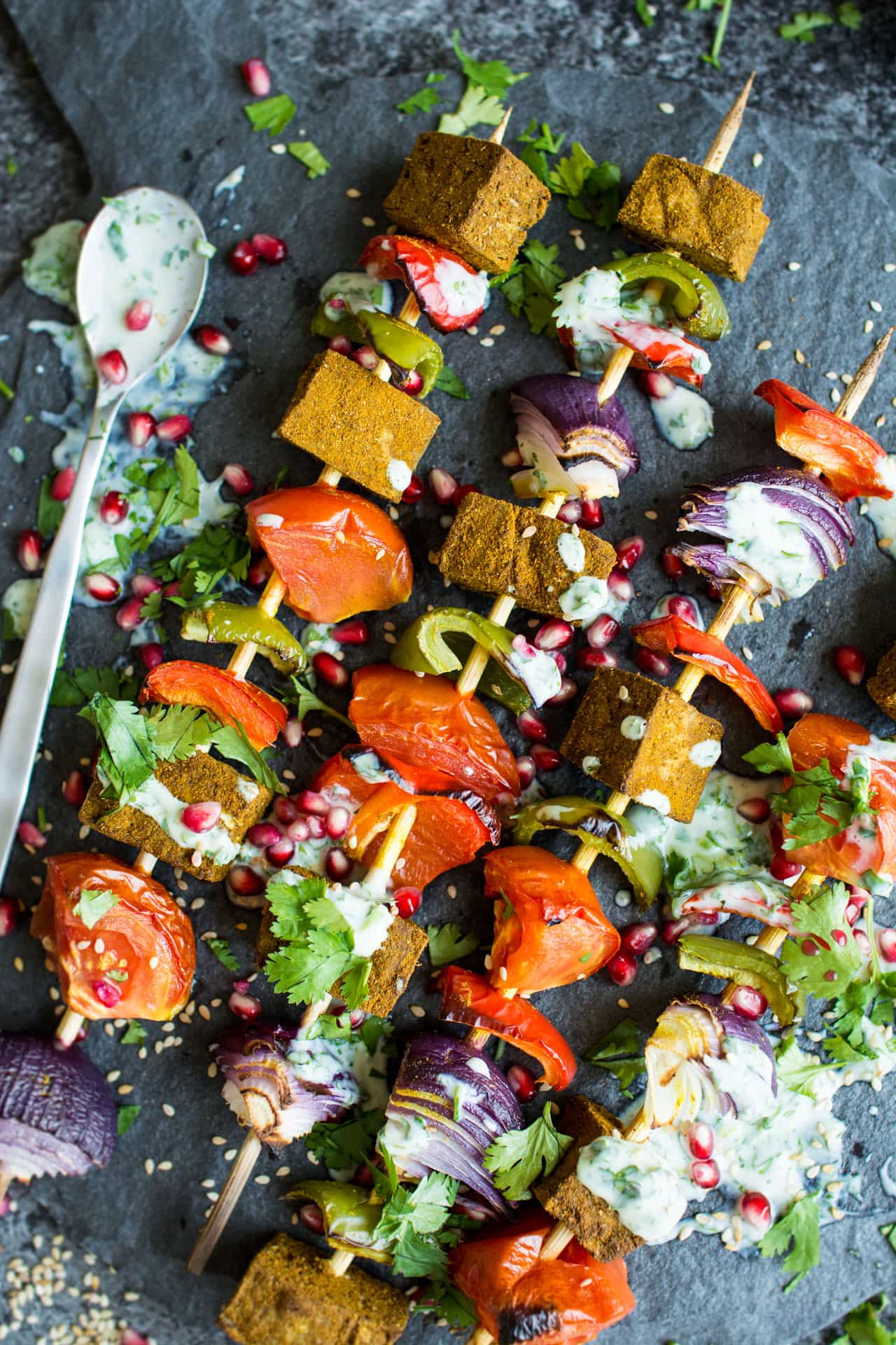 Grilled tofu kebobs on a dark background