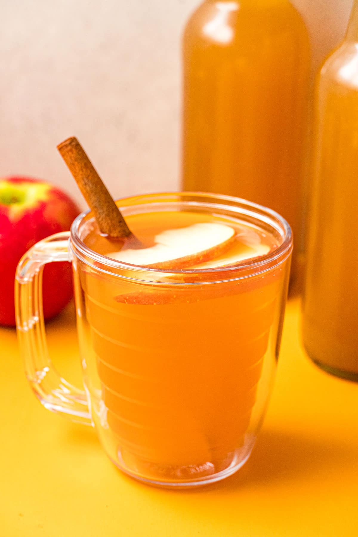 Homemade apple cider in a clear mug.