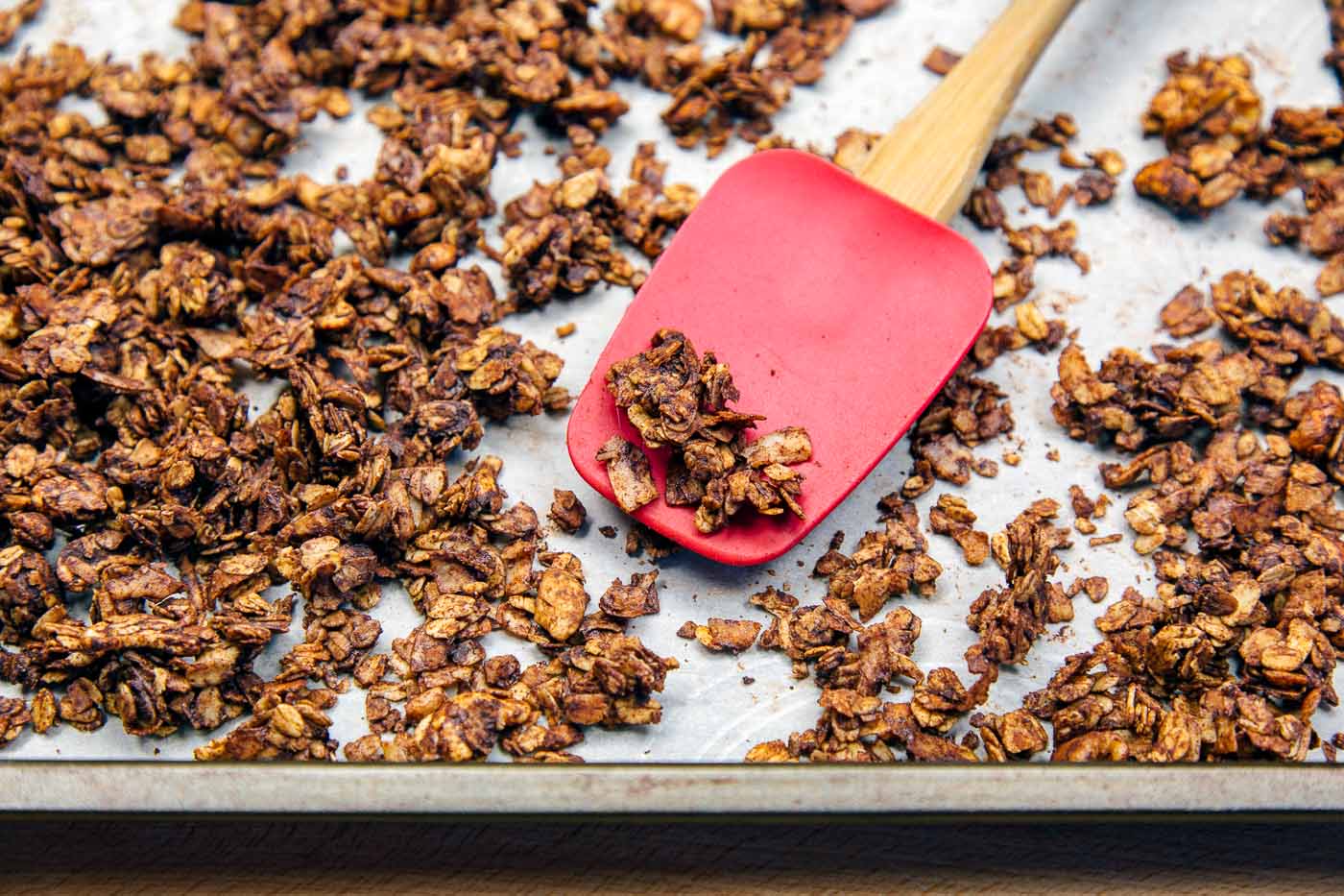 Coconut chocolate granola on a baking sheet