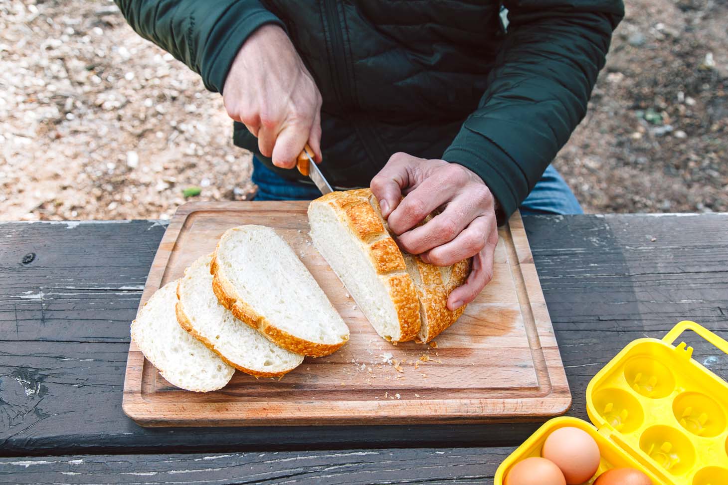 Michael slicing a loaf of bread for French toast