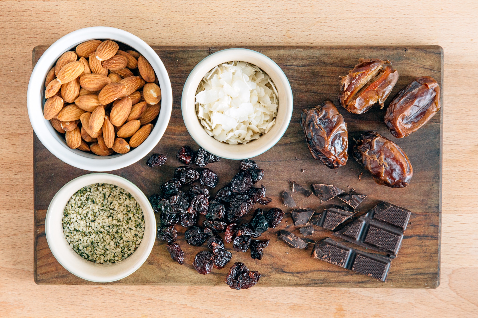 Ingredients for chocolate cherry energy balls on a wooden surface