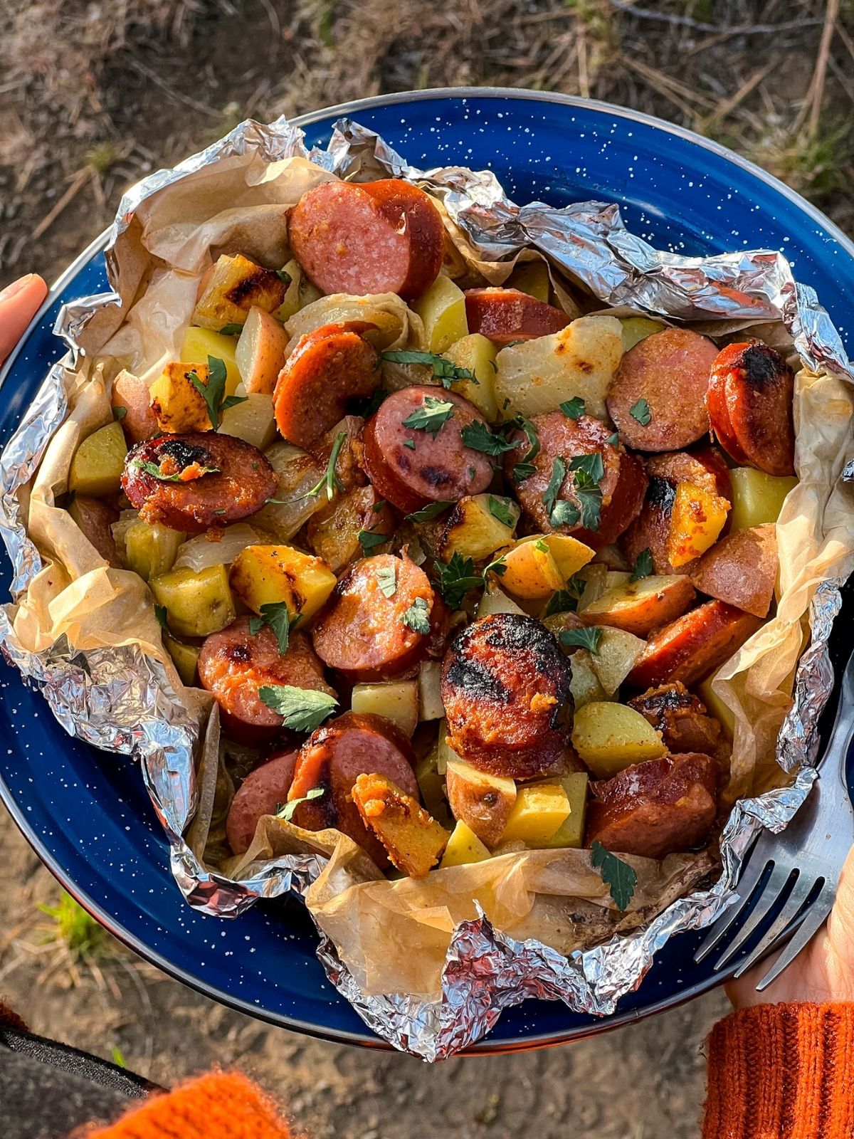 Kielbasa foil packet on a blue plate