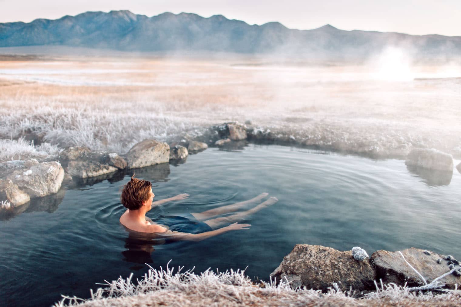 Michael sitting in a hot spring