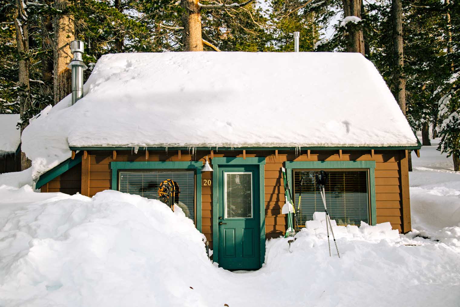 A rustic cabin covered in snow