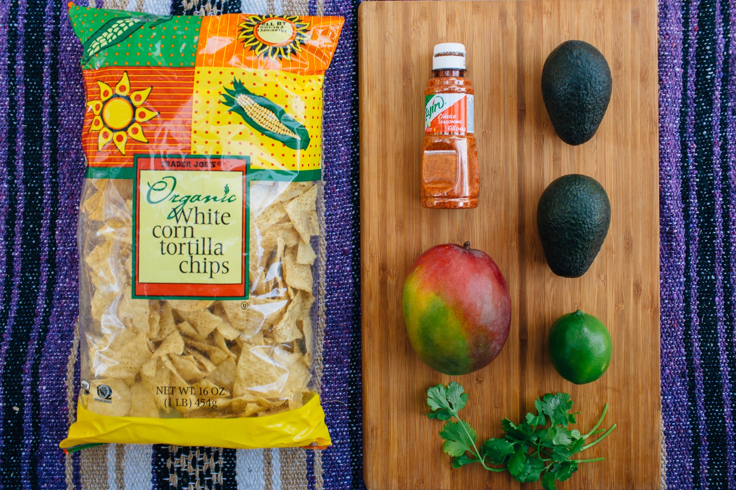 Ingredients for mango guacamole laid out on a cutting board