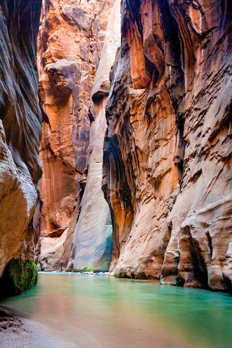 Orange canyon walls rising up from a river