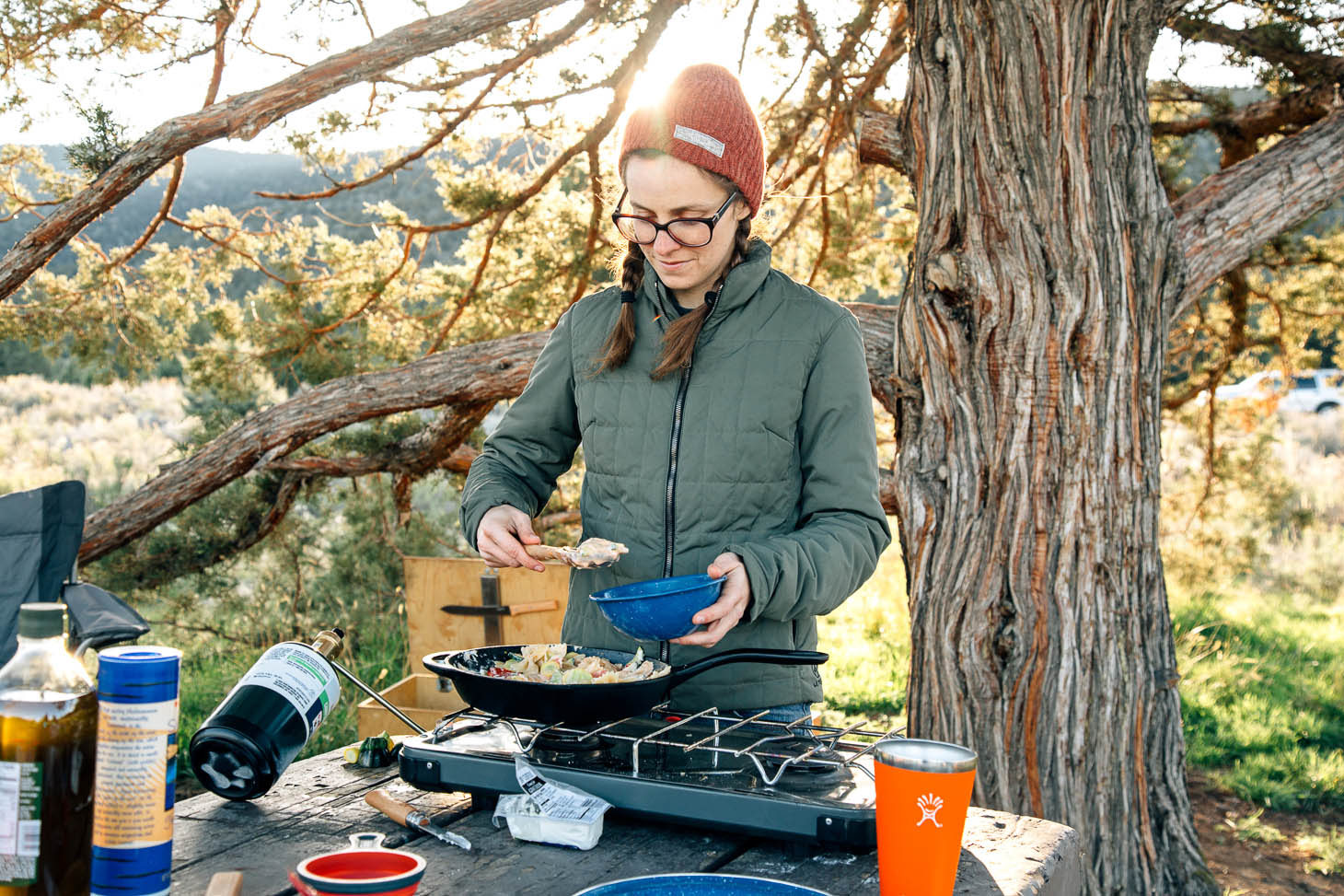 Serving a bowl of pasta primavera at a campsite.