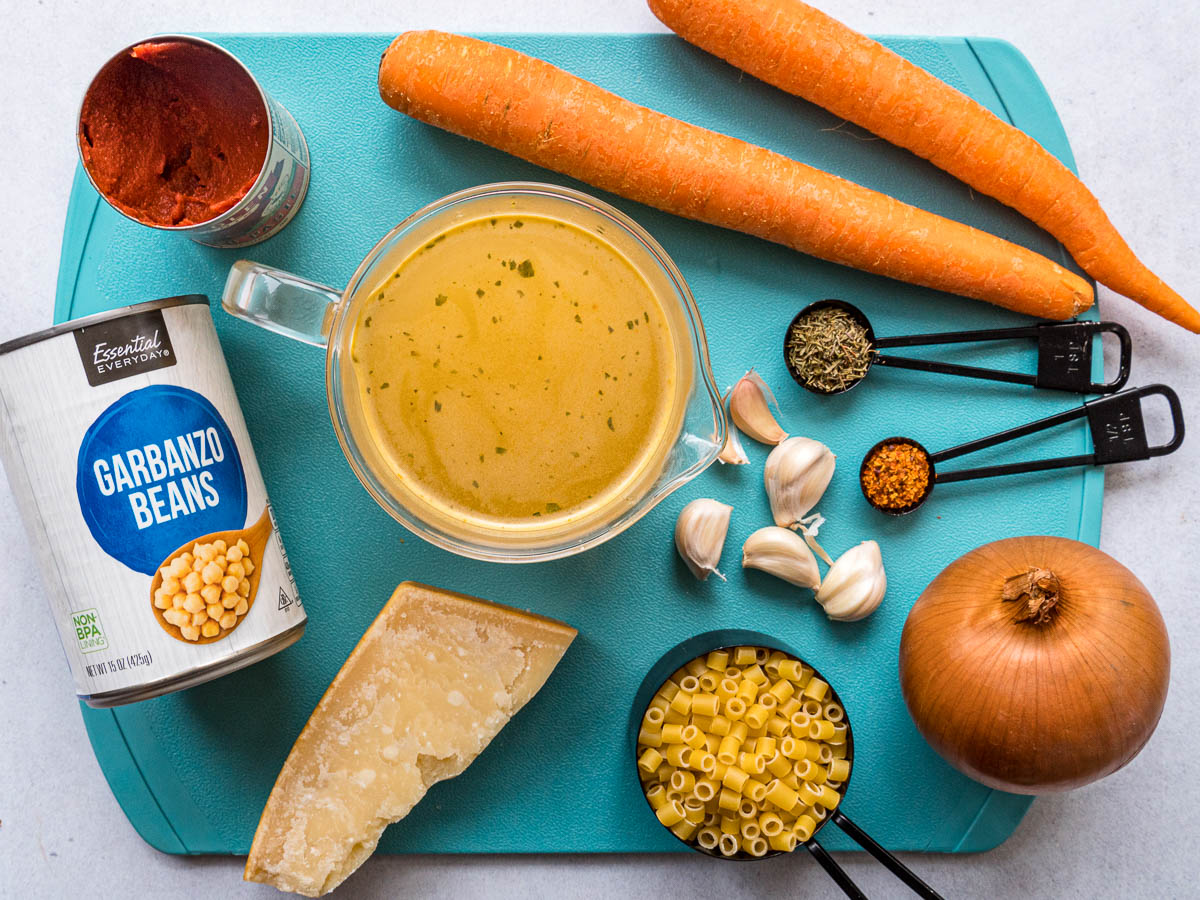 Ingredients for pasta e ceci on a blue cutting board