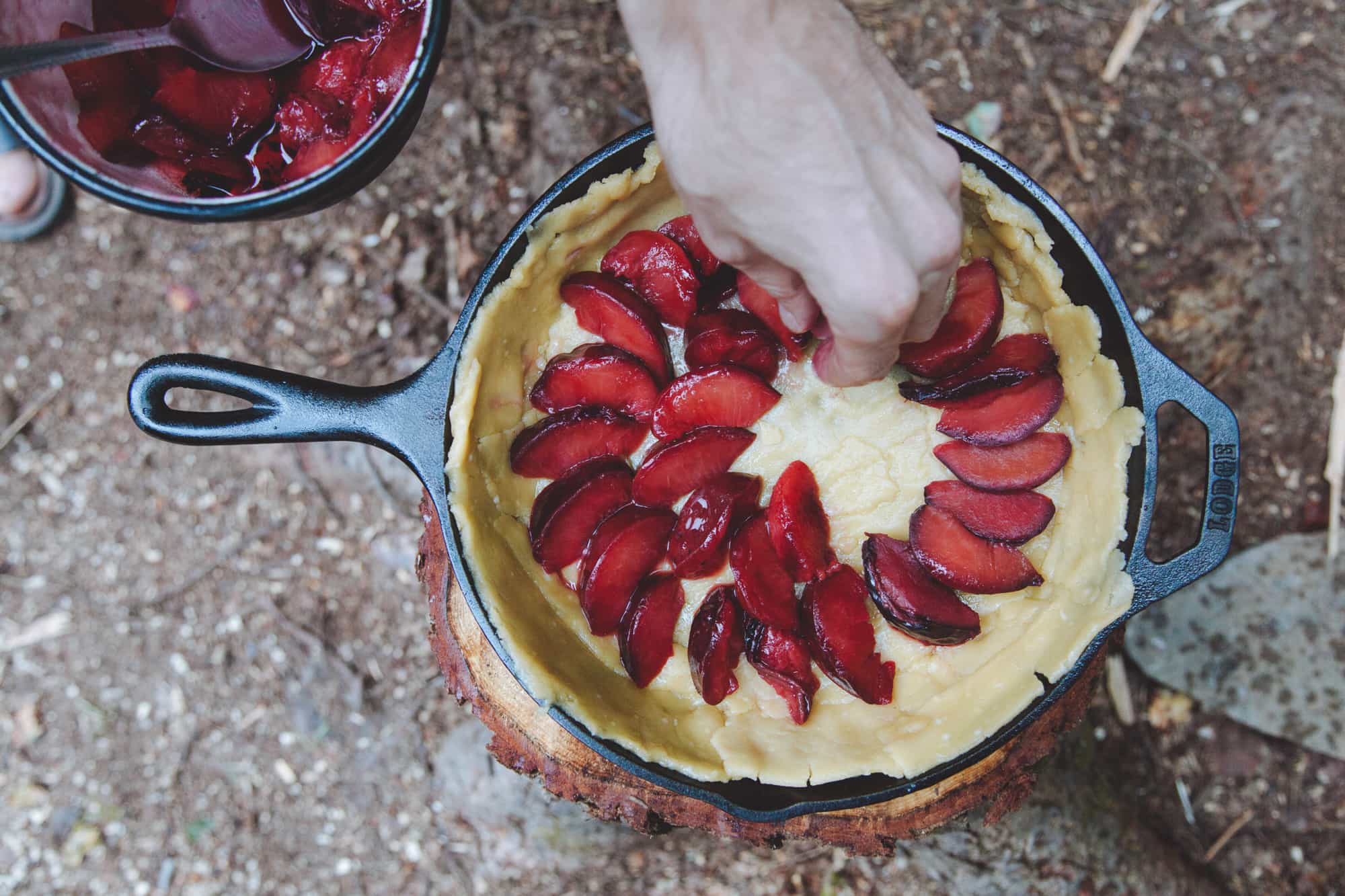 Building a plum tart in a cast iron skillet.