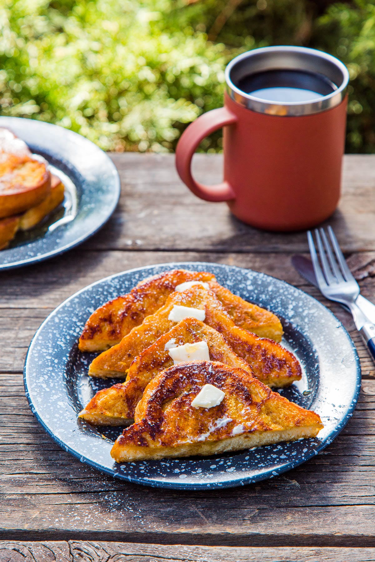 Four slices of pumpkin French toast on a blue plate