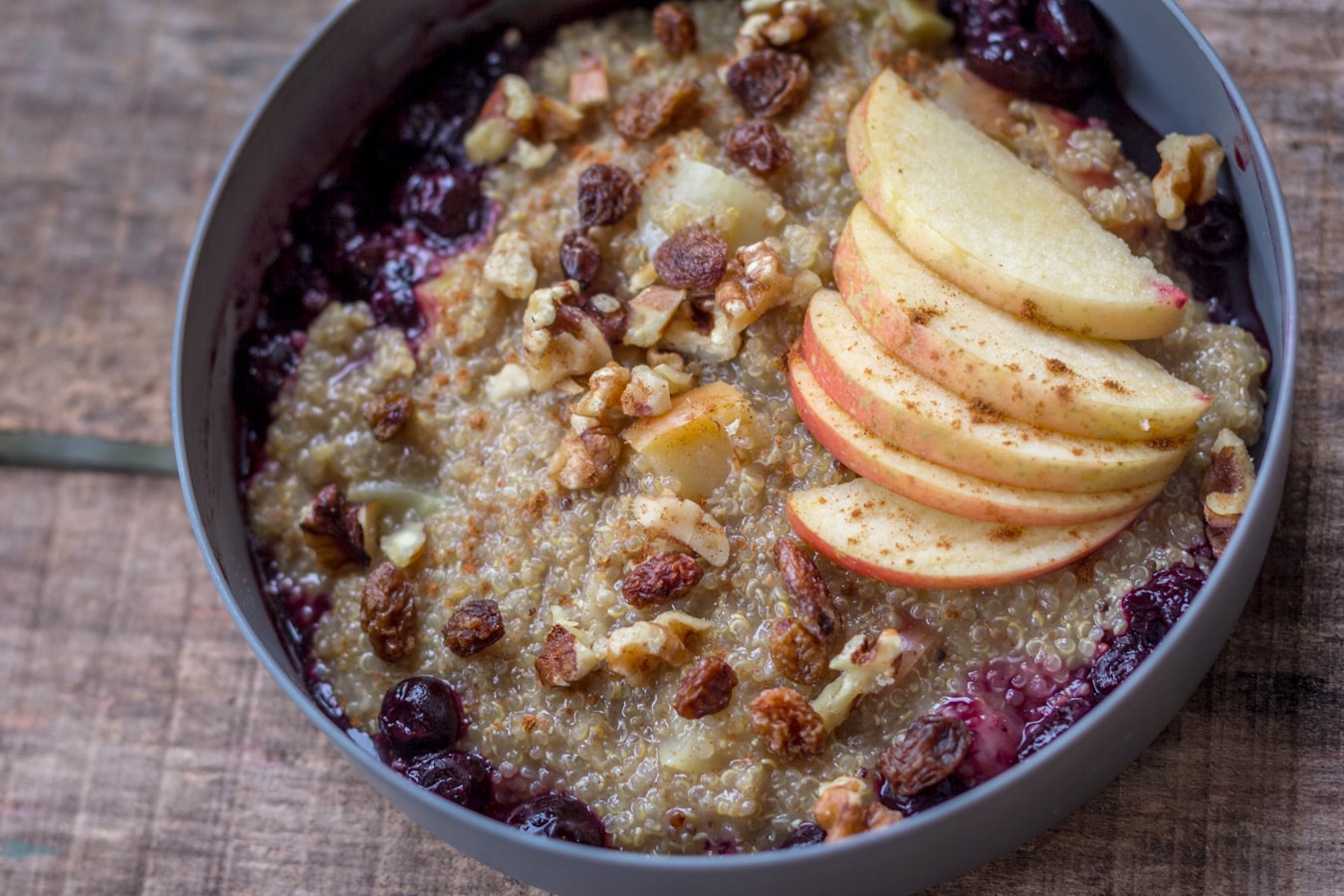 Bowl of quinoa porridge with apples.