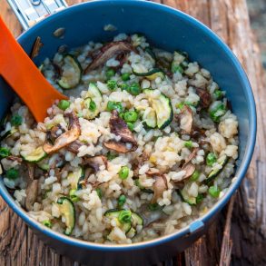 A pot of risotto on a log