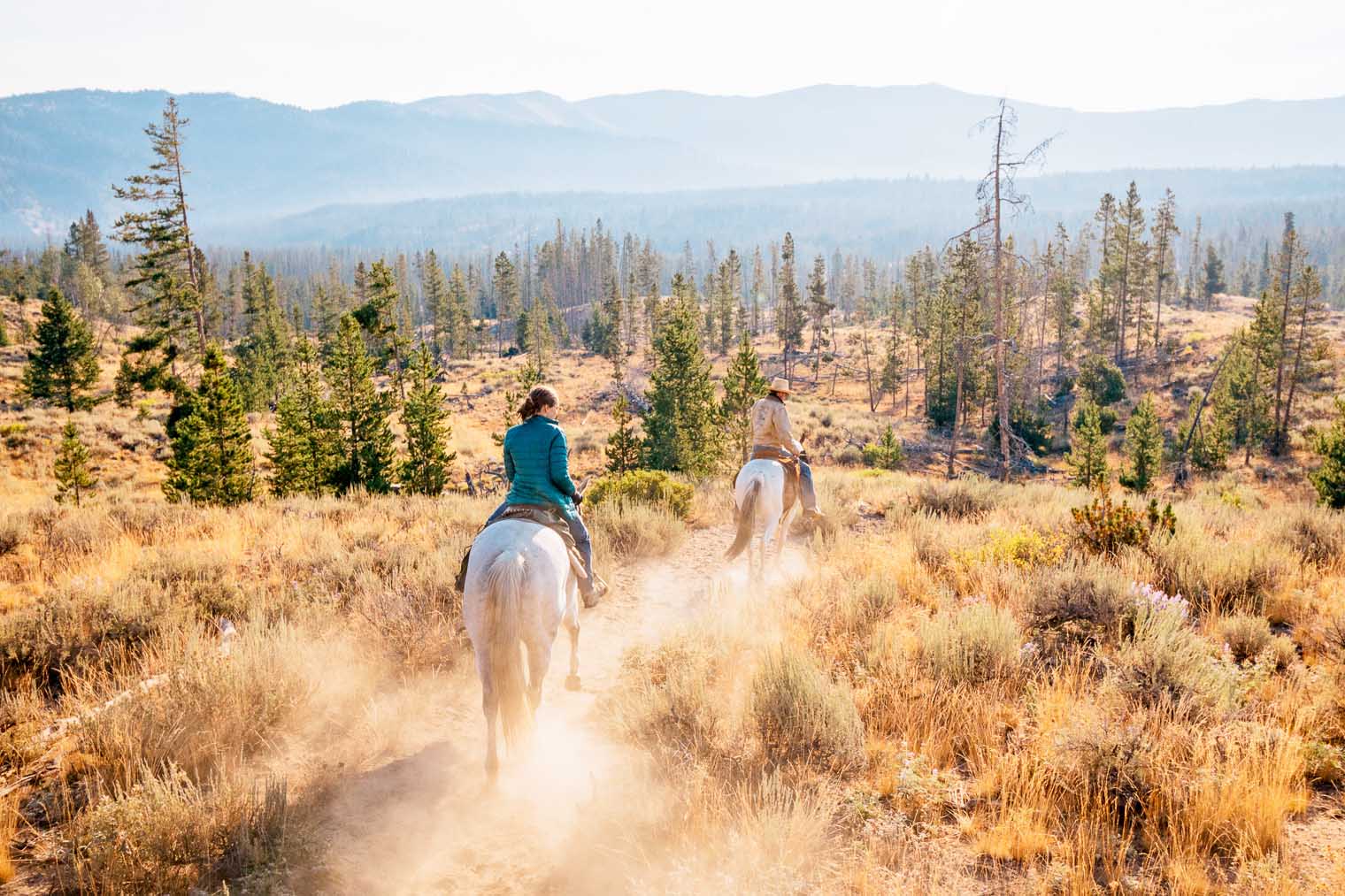 Megan riding horseback in the sawtooth mountains