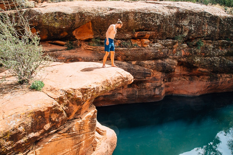 Michael on a rock outcropping looking down at the crack swimming hole