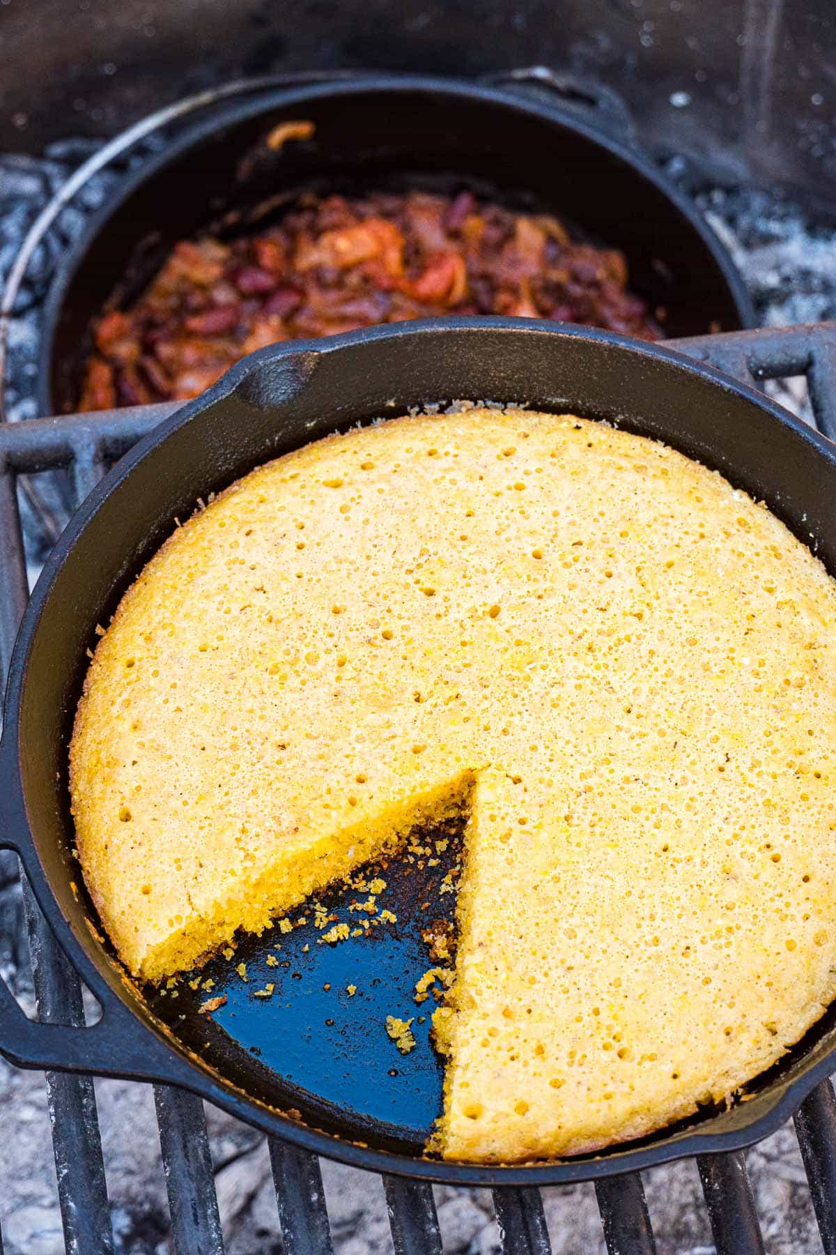 Cornbread in a skillet over a campfire